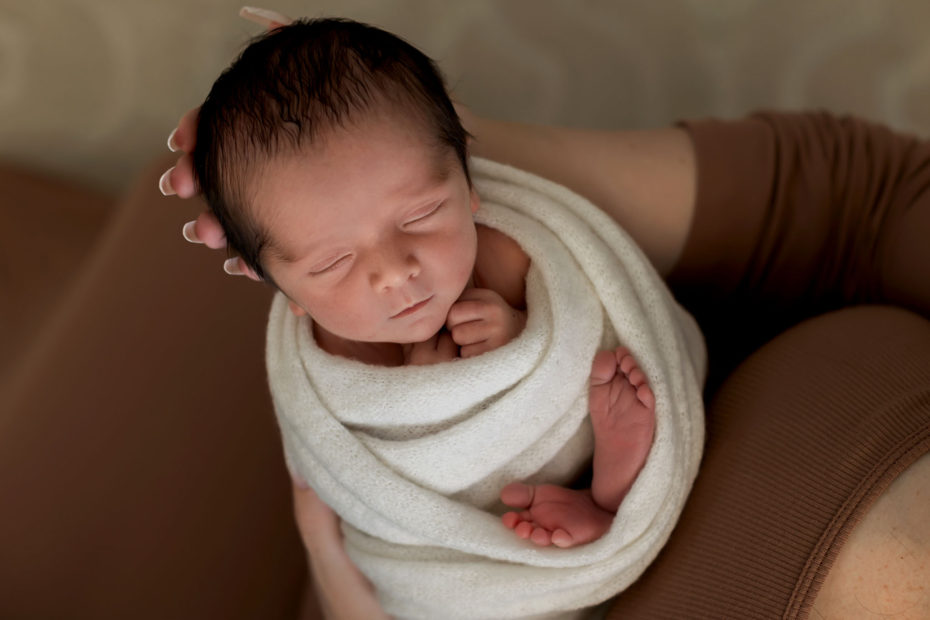 newborn baby in mother's arms.