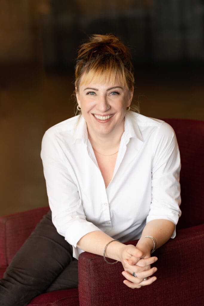 Professional woman in white shirt posing for a photographer for her headshot in SF bay area.