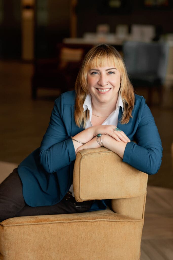 A professional writer relaxed in a chair at a personal branding photoshoot in SF Bay Area.