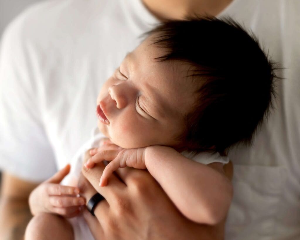 Baby boy held by his father